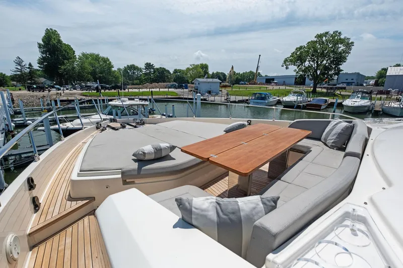 Slide: The Image of Luxurious 2018 Ferretti Yachts 780 with spacious deck seating and wooden table, docked at marina. - 24
