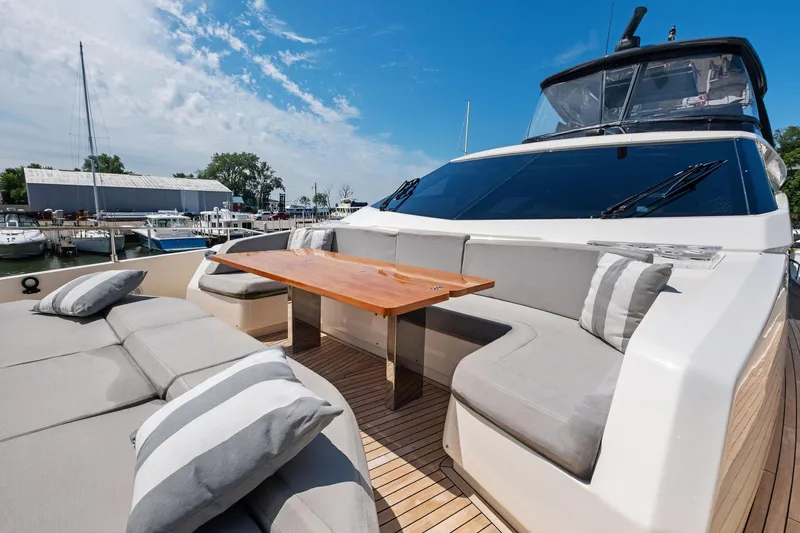 Slide: The Image of Luxurious 2018 Ferretti Yachts 780 with elegant outdoor seating and table, docked at marina. - 25