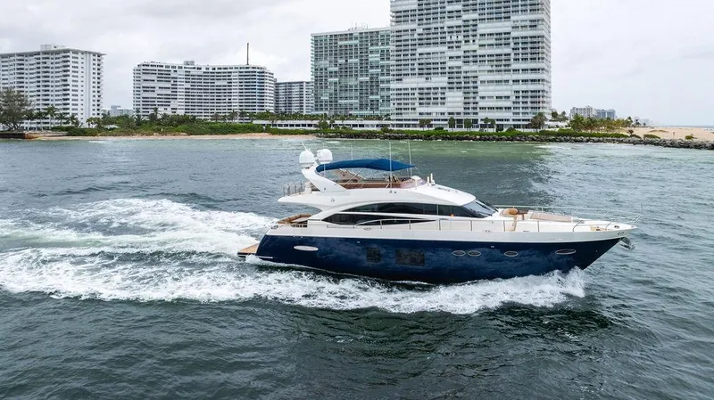 Slide: The Image of 2012 Princess 72 Motor Yacht cruising near modern waterfront buildings. - 3