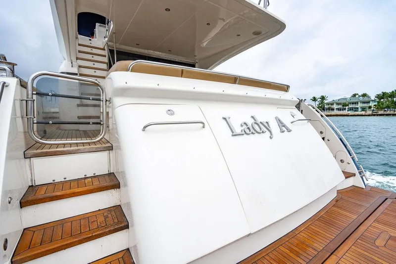 Slide: The Image of Princess 72 Motor Yacht 2012, named "Lady A," docked with wooden steps and sleek design. - 35