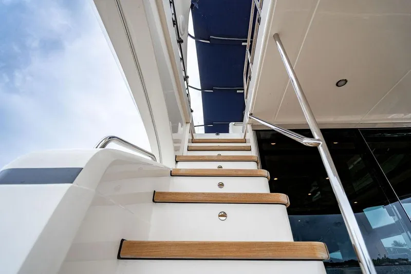 Slide: The Image of Staircase on 2012 Princess 72 Motor Yacht, featuring sleek design and wooden steps. - 40