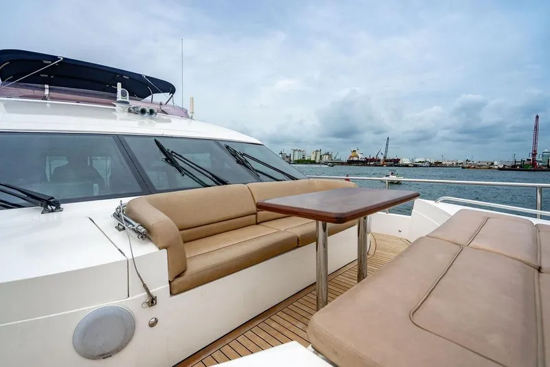 Slide: The Image of Luxurious 2012 Princess 72 Motor Yacht with spacious deck seating and scenic waterfront view. - 47
