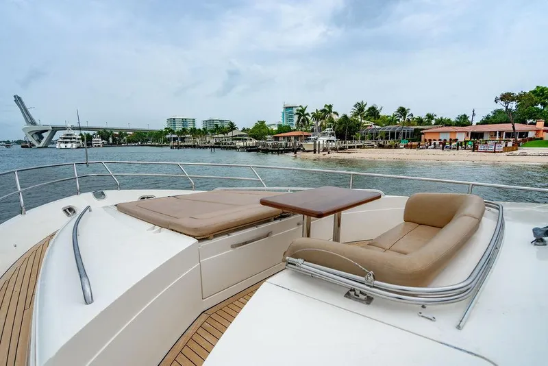 Slide: The Image of Luxurious 2012 Princess 72 Motor Yacht with spacious deck, overlooking serene waterfront and modern architecture. - 48