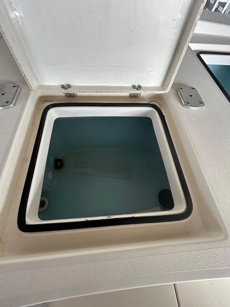 Slide: The Image of Storage compartment on 2023 Pathfinder 2300 HPS boat with organized gear and equipment. - 13