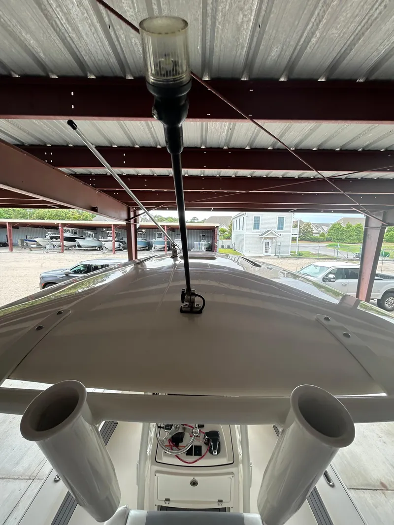 Slide: The Image of 2023 Pathfinder 2300 HPS boat interior with fishing gear and storage compartments. - 16