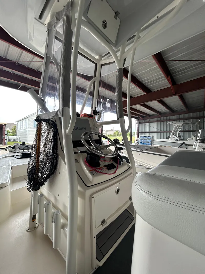 Slide: The Image of 2023 Pathfinder 2300 HPS boat on trailer in covered storage area. - 2