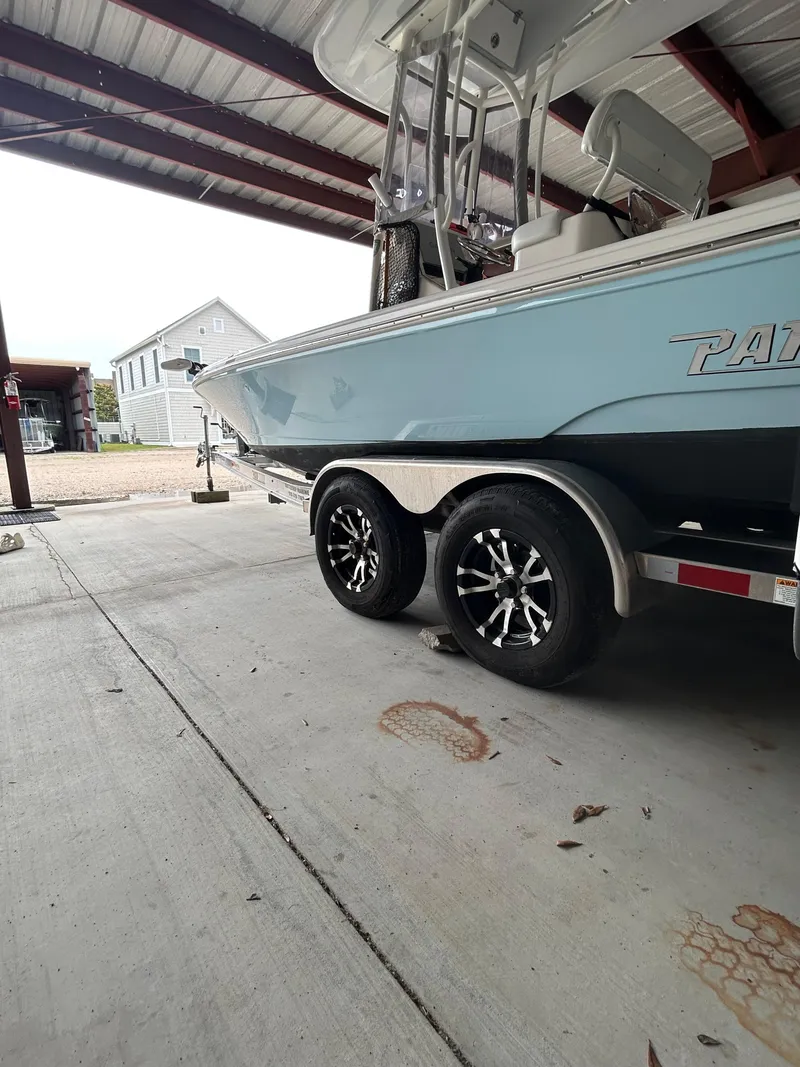 Slide: The Image of 2023 Pathfinder 2300 HPS boat under a metal canopy, showcasing its sleek design. - 23