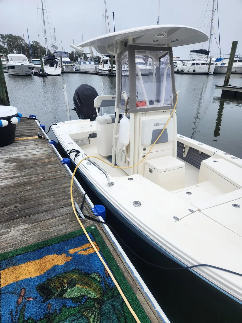 Slide: The Image of 2023 Pathfinder 2300 HPS boat in storage, featuring Garmin equipment and trailer cover. - 25