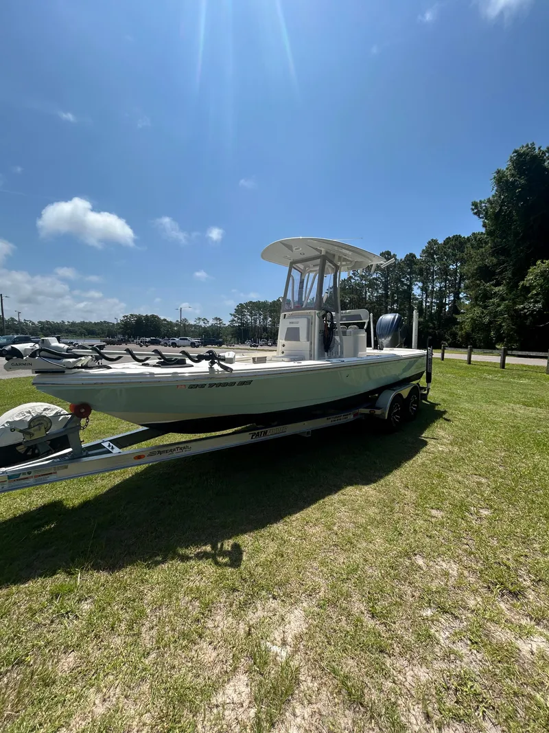 Slide: The Image of 2023 Pathfinder 2300 HPS boat on trailer under clear blue sky. - 32