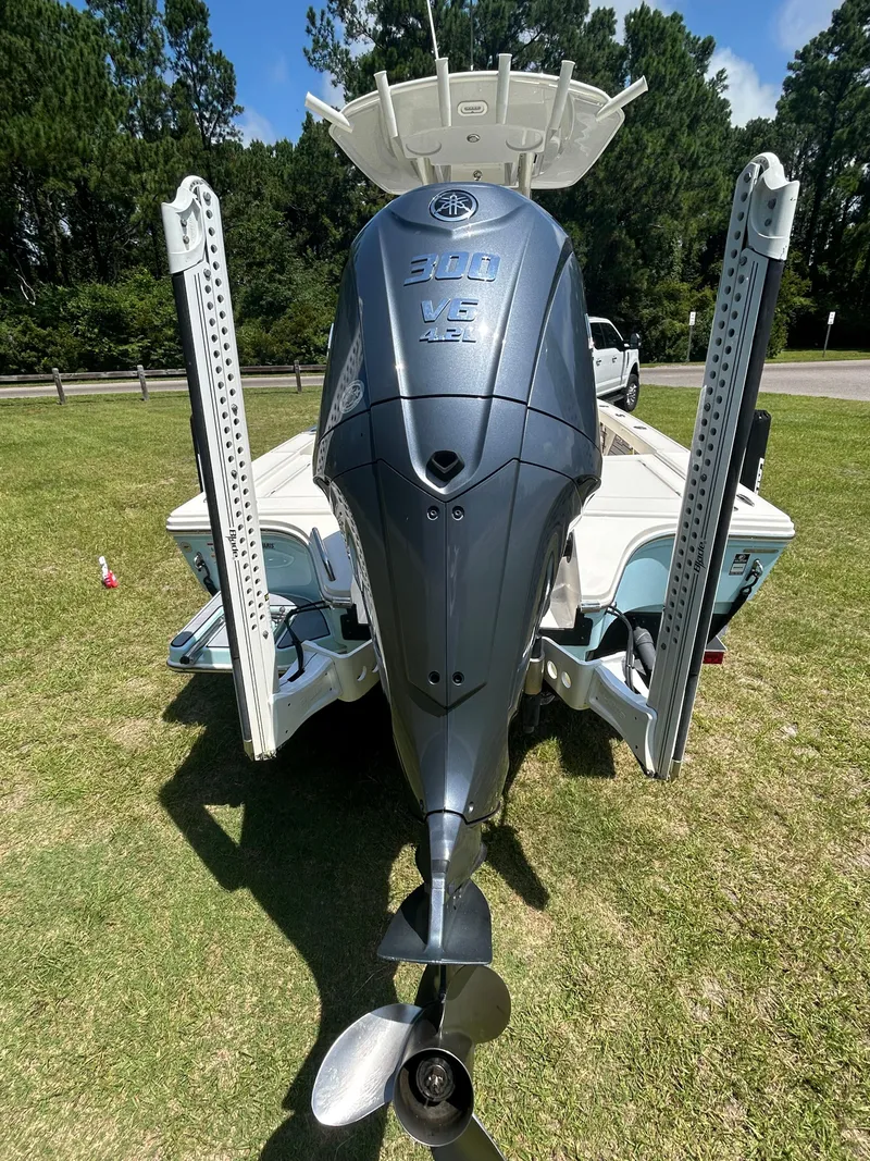 Slide: The Image of 2023 Pathfinder 2300 HPS boat with powerful outboard motor on grassy area. - 34