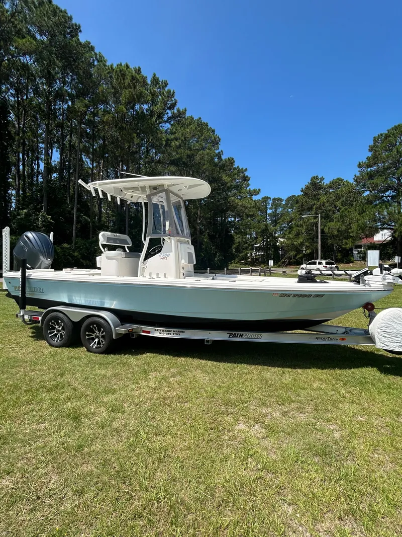 Slide: The Image of 2023 Pathfinder 2300 HPS boat on trailer, parked on grass under clear blue sky. - 35