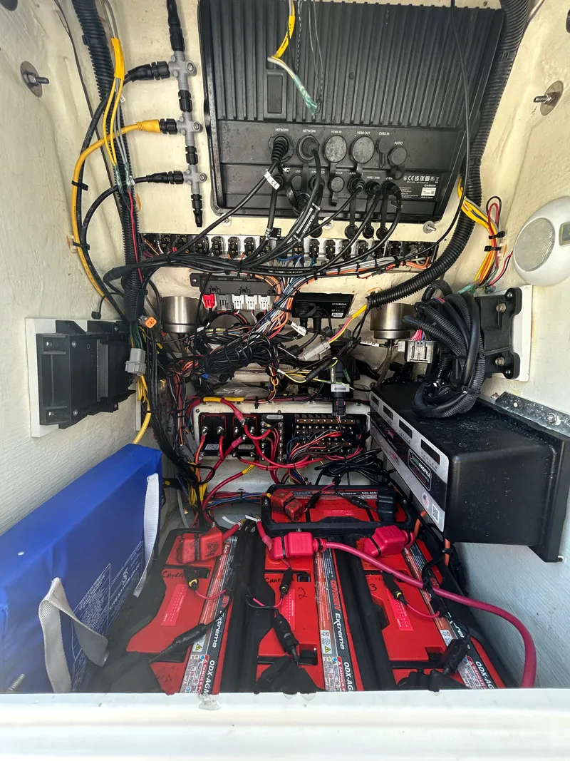 Slide: The Image of 2023 Pathfinder 2300 HPS boat on grass, featuring a sleek design and center console. - 44