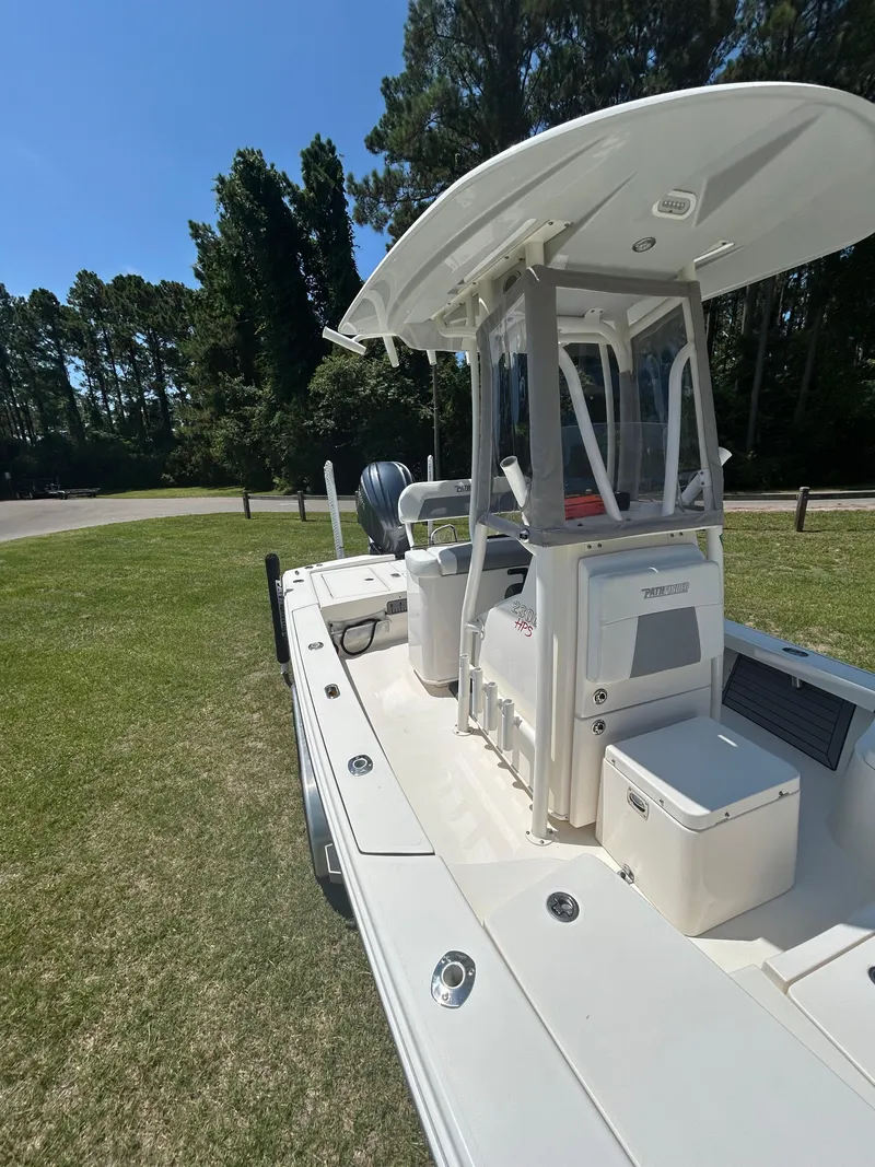 Slide: The Image of 2023 Pathfinder 2300 HPS boat on trailer with Garmin equipment, parked on grass. - 45