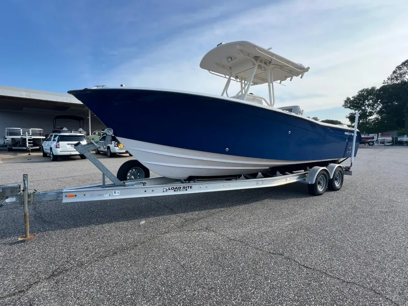 Slide: The Image of 2002 Grady-White Chase 273 boat on trailer in parking lot, side view. - 13