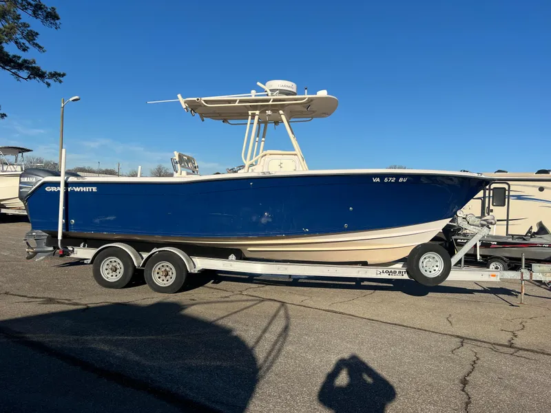 Slide: The Image of 2002 Grady-White Chase 273 boat on trailer, parked outdoors, with Yamaha engine. - 17