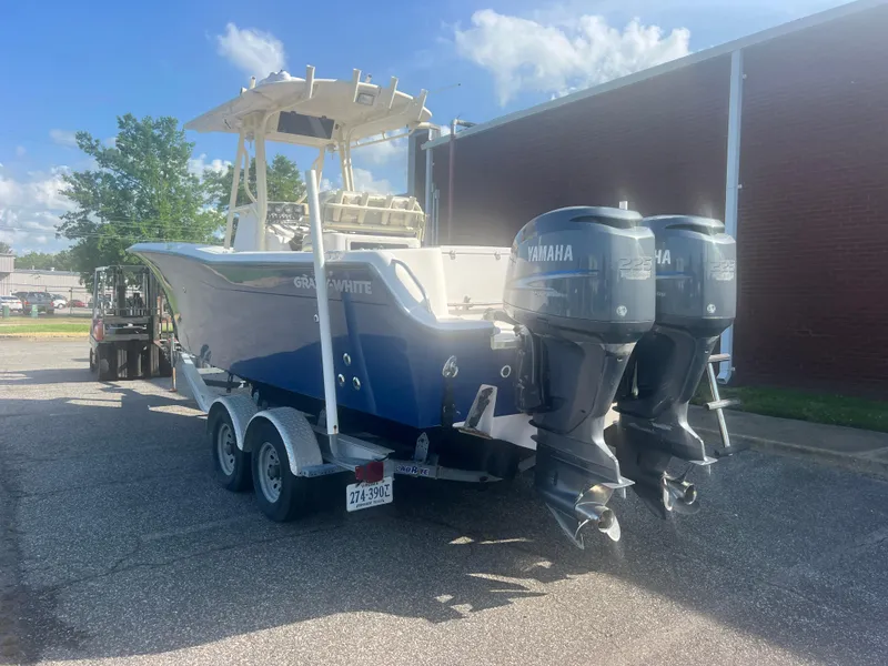Slide: The Image of 2002 Grady-White Chase 273 boat with twin Yamaha engines on a trailer. - 21