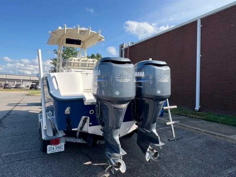 Slide: The Image of 2002 Grady-White Chase 273 boat on trailer, blue hull, parked outdoors. - 24