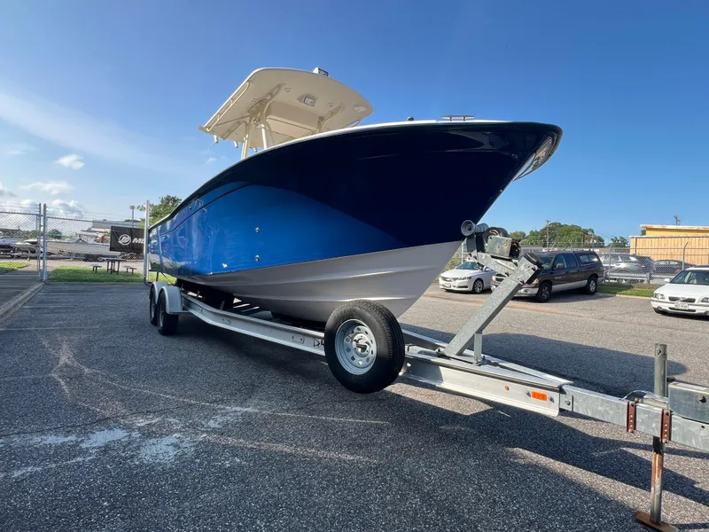Slide: The Image of 2002 Grady-White Chase 273 boat interior with seating and console, parked outdoors. - 29
