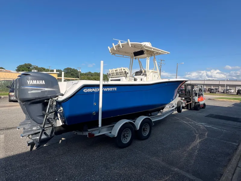 Slide: The Image of 2002 Grady-White Chase 273 boat interior with steering console and rod holders. - 30