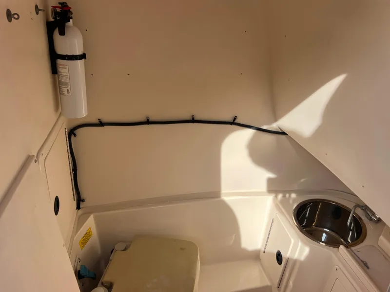 Slide: The Image of 2002 Grady-White Chase 273 boat interior with cushioned seating and console. - 39