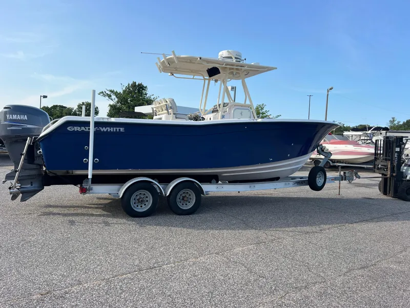 Slide: The Image of 2002 Grady-White Chase 273 boat on trailer with Yamaha engines, parked outdoors. - 4