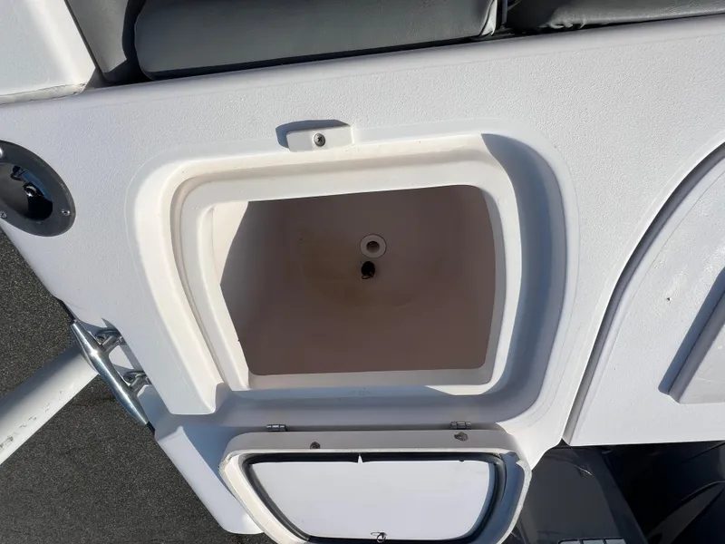 Slide: The Image of 2002 Grady-White Chase 273 boat interior with rod holders and storage compartment. - 49