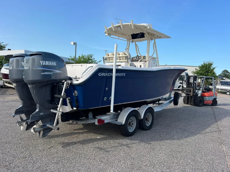 Slide: The Image of 2002 Grady-White Chase 273 boat on trailer, blue hull, parked outdoors. - 6