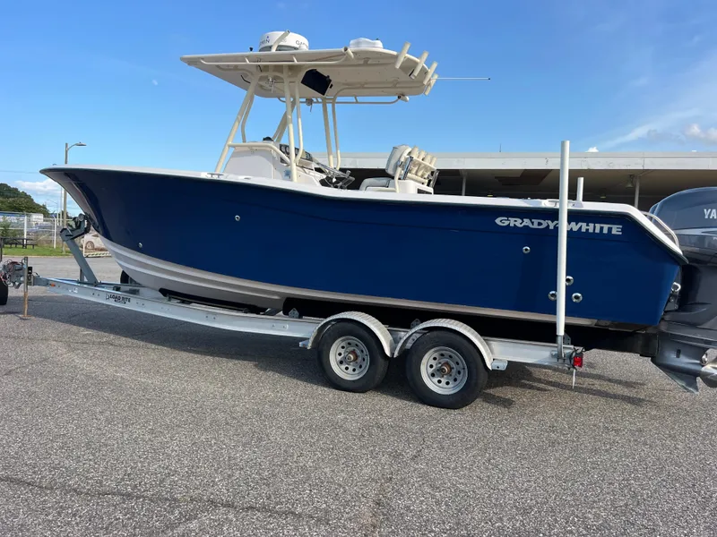 Slide: The Image of 2002 Grady-White Chase 273 boat on trailer, parked outdoors, under clear sky. - 9