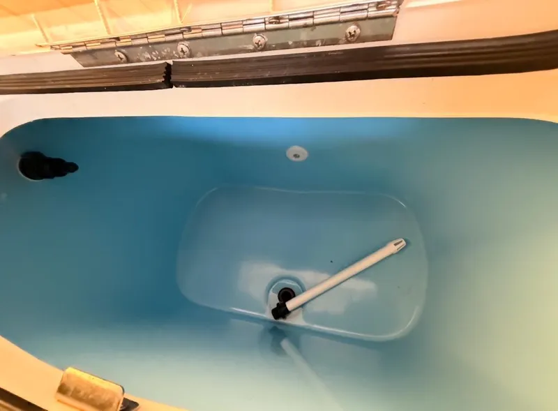 Slide: The Image of Interior view of a 2003 Storm Boats 21, featuring a blue compartment. - 12