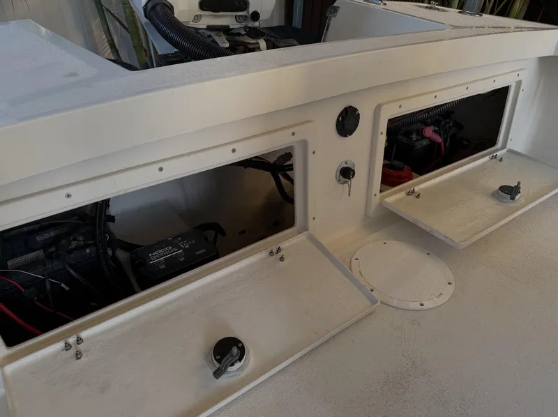 Slide: The Image of 2003 Storm Boats 21 model showing open storage compartments and engine components. - 13