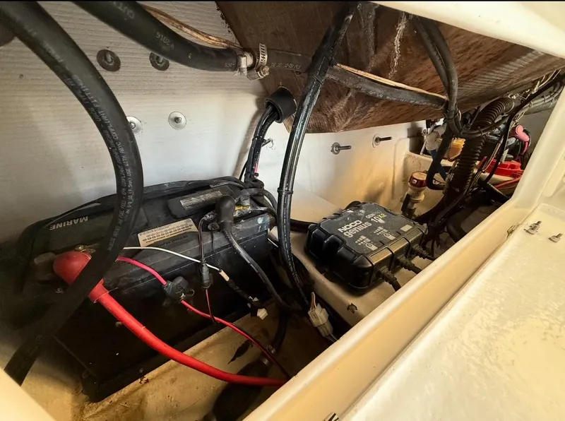 Slide: The Image of Engine compartment of a 2003 Storm Boats 21, showing battery and wiring. - 14