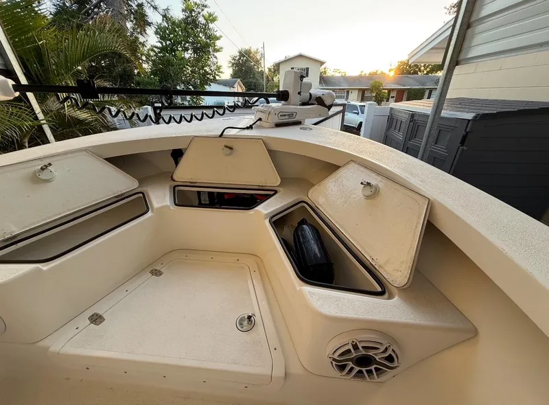 Slide: The Image of 2003 Storm Boats 21 model with open storage compartments and speaker, parked outdoors. - 4