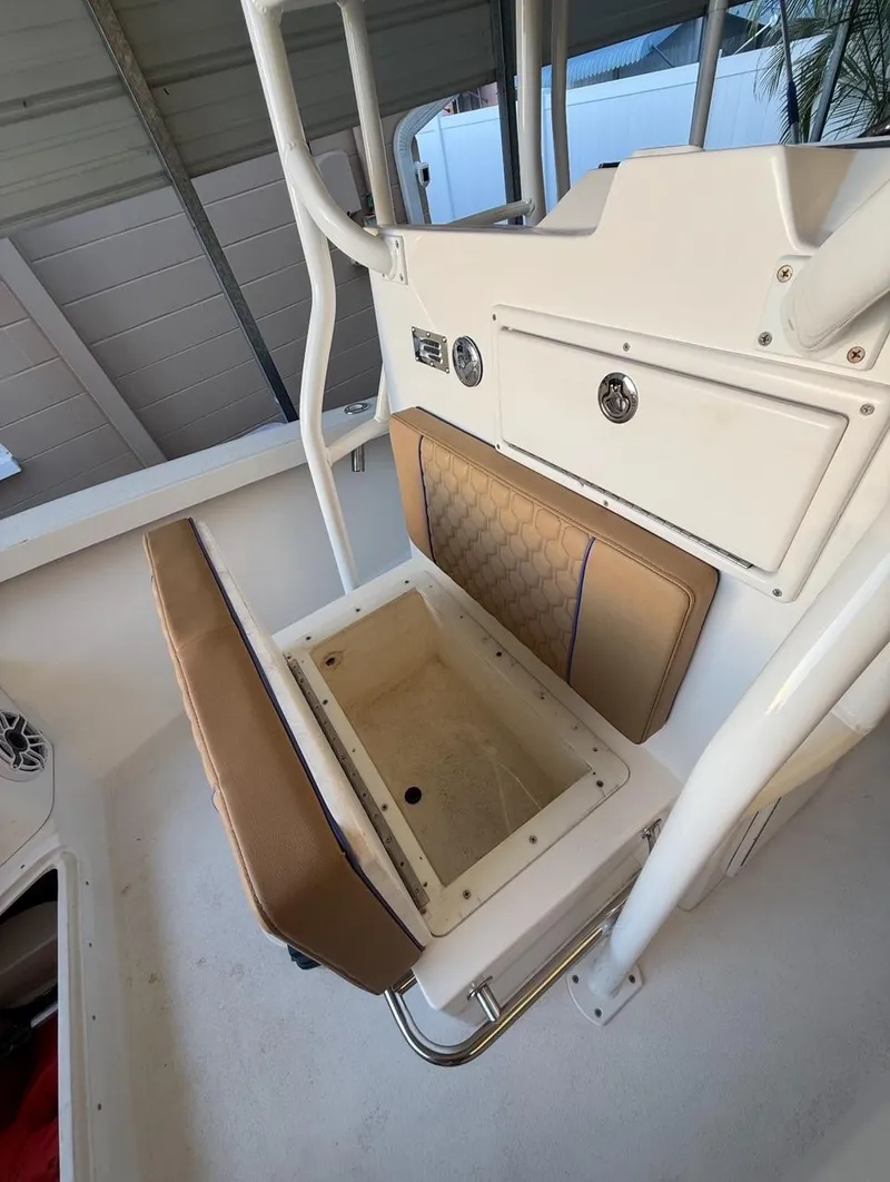 Slide: The Image of 2003 Storm Boats 21 model with open storage compartment and cushioned seating. - 6