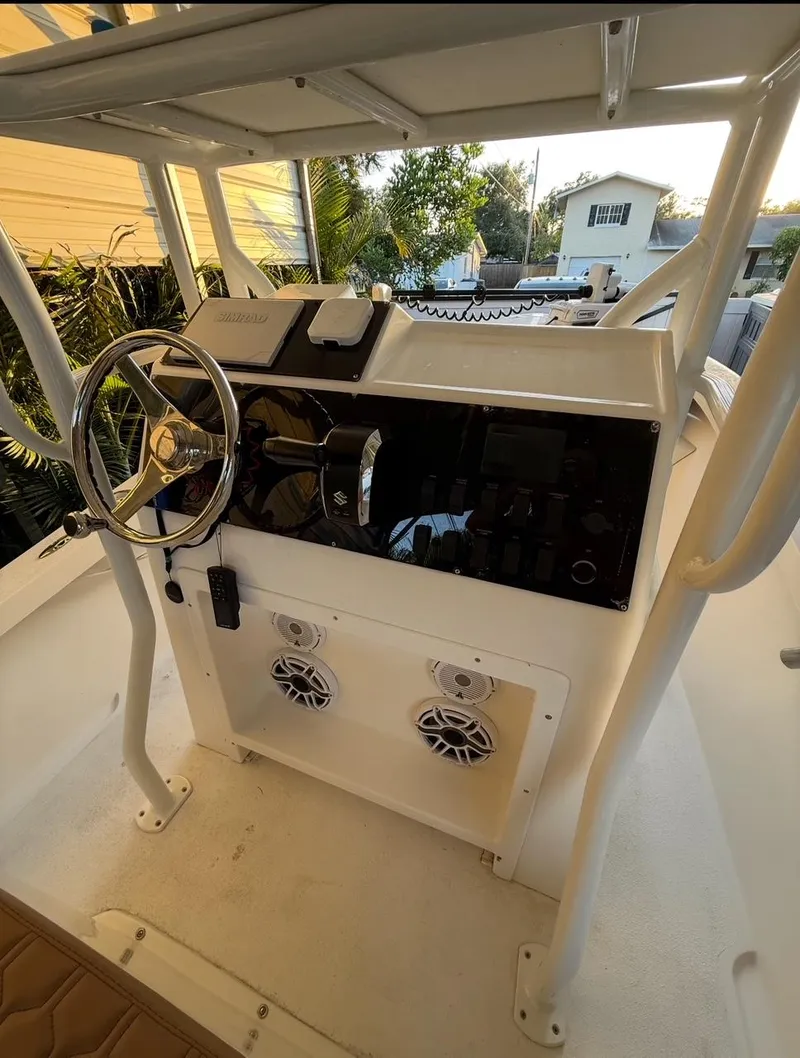 Slide: The Image of 2003 Storm Boats 21 console with steering wheel and controls. - 8