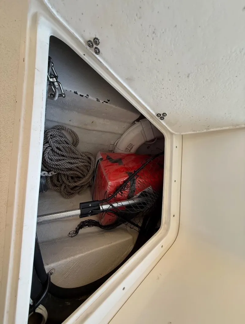 Slide: The Image of Storage compartment in a 2003 Storm Boats model 21, containing rope and safety equipment. - 9