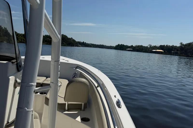 Slide: The Image of 2023 Key West 203 FS boat on calm lake under clear blue sky. - 11