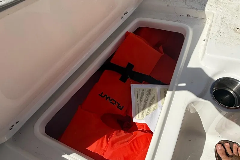 Slide: The Image of 2023 Key West 203 FS boat storage with life jacket and document inside. - 13