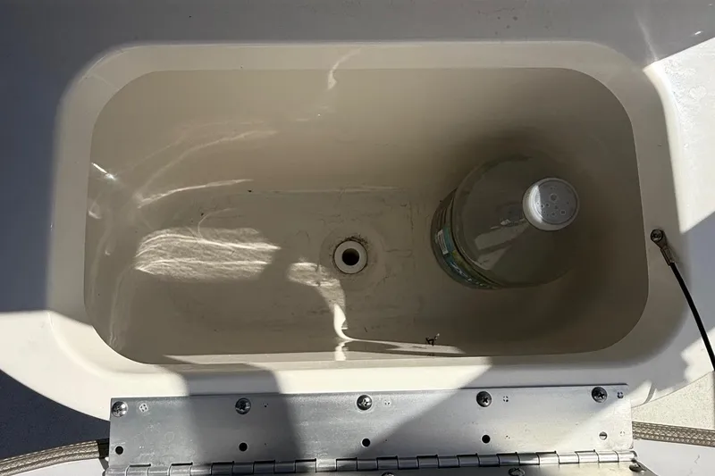 Slide: The Image of Livewell in 2023 Key West 203 FS boat with a bottle inside. - 14