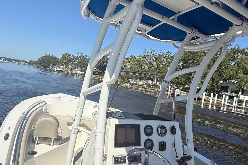 Slide: The Image of 2023 Key West 203 FS boat navigating a scenic river with clear blue skies. - 15