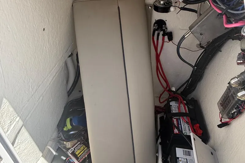 Slide: The Image of 2023 Key West 203 FS boat interior showing battery compartment and wiring setup. - 16