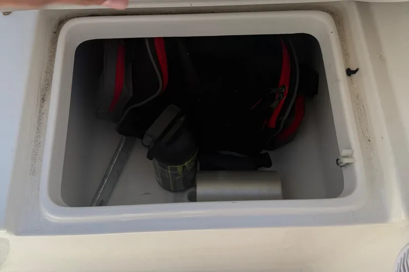 Slide: The Image of Storage compartment on a 2023 Key West 203 FS boat with gear and accessories. - 20