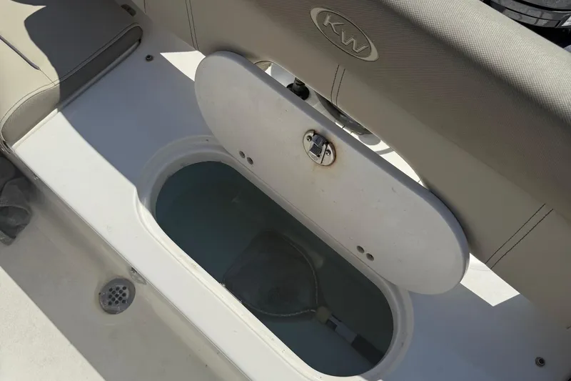 Slide: The Image of 2023 Key West 203 FS boat livewell with open lid and visible interior. - 21