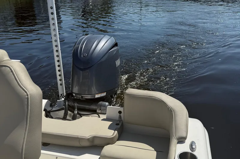 Slide: The Image of 2023 Key West 203 FS boat with outboard motor on calm water. - 22