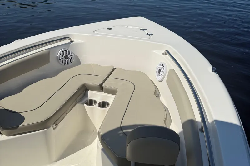 Slide: The Image of 2023 Key West 203 FS boat interior with beige seating and cup holders. - 23