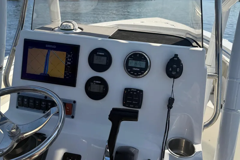 Slide: The Image of 2023 Key West 203 FS boat dashboard with navigation and control instruments. - 27
