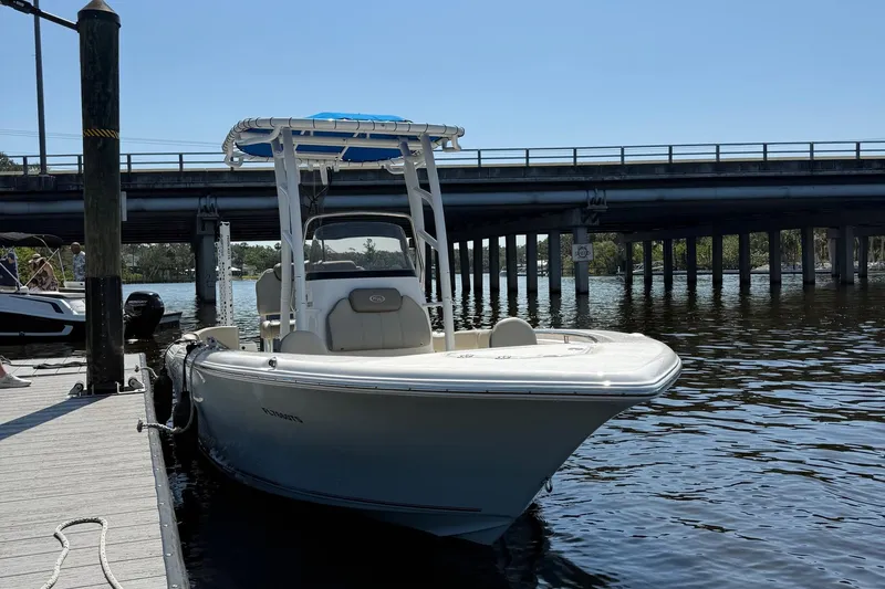Slide: The Image of 2023 Key West 203 FS boat docked near a bridge on a sunny day. - 4