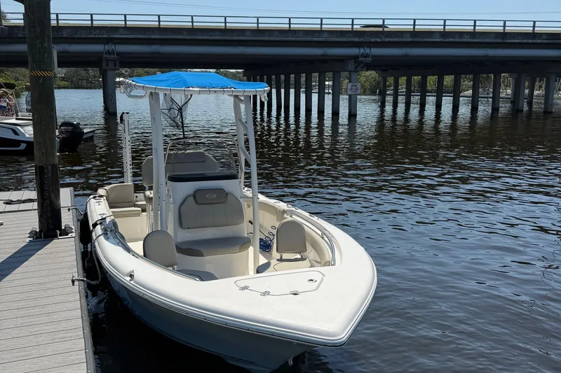Slide: The Image of 2023 Key West 203 FS boat docked by a bridge on a sunny day. - 5