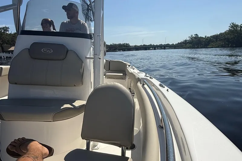 Slide: The Image of 2023 Key West 203 FS boat cruising on a calm lake under clear skies. - 6