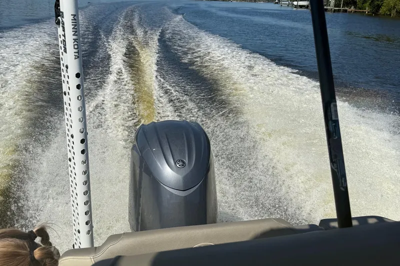 Slide: The Image of 2023 Key West 203 FS boat cruising on a lake, leaving a wake behind. - 7