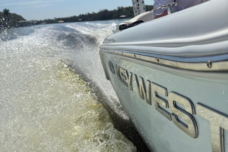 Slide: The Image of 2023 Key West 203 FS boat speeding on water, creating a dynamic wake. - 8